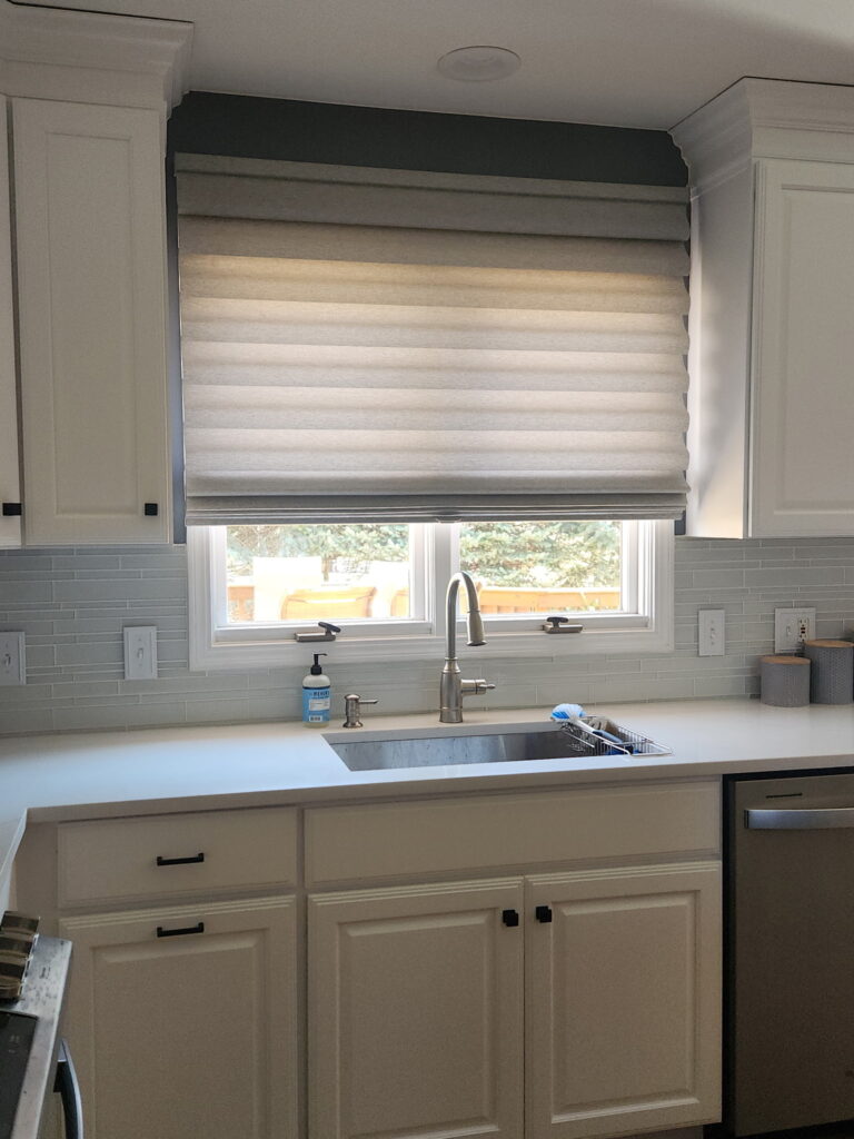 hunter Douglas vignette Roman shade hanging above a kitchen sink