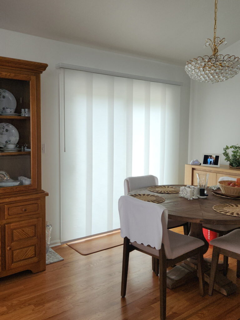 hunter Douglas skyline panel track blinds as a door covering for a sliding glass door in this elegant Downers Grove kitchen