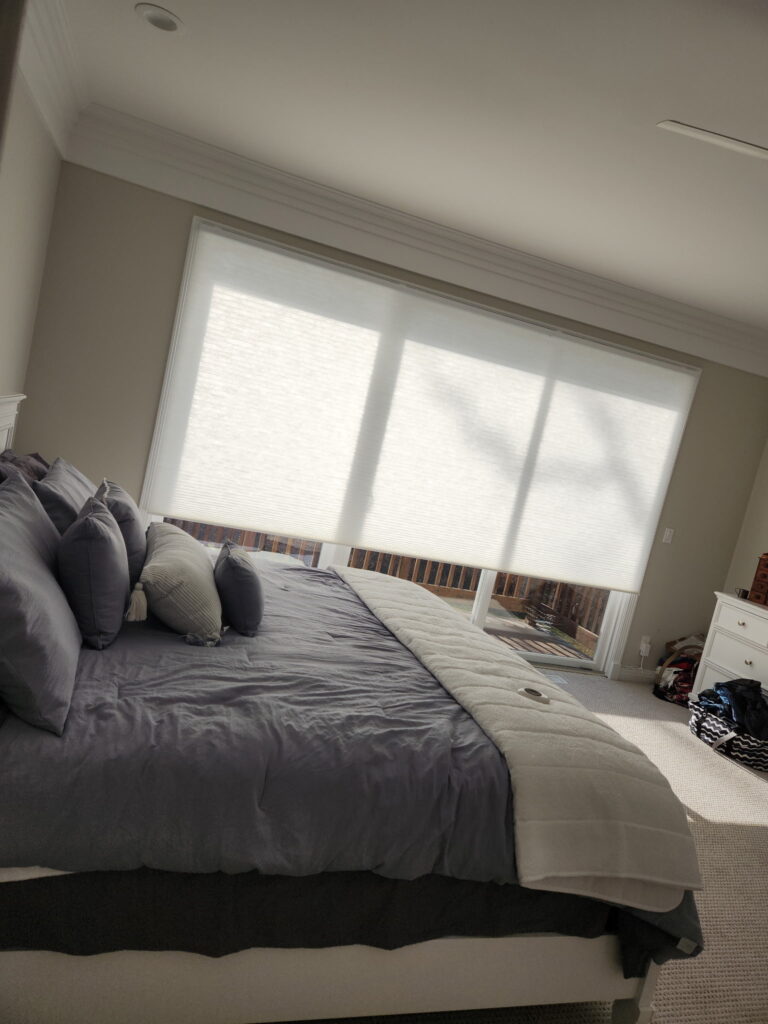 142 inch Hunter Douglas Applause Honeycombs PowerView blinds hanging in an Oswego, IL bedroom