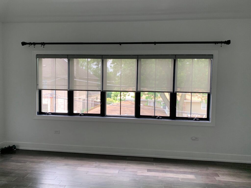 Gray hunter Douglas designer roller shades against a white wall