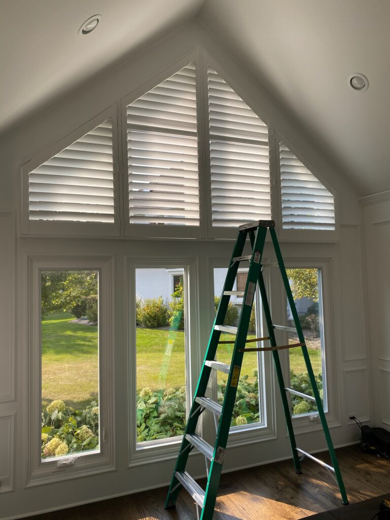 Custom made Hunter Douglas Shutters in high, angled windows. Installed by Ogden Blinds in Plainfield, IL