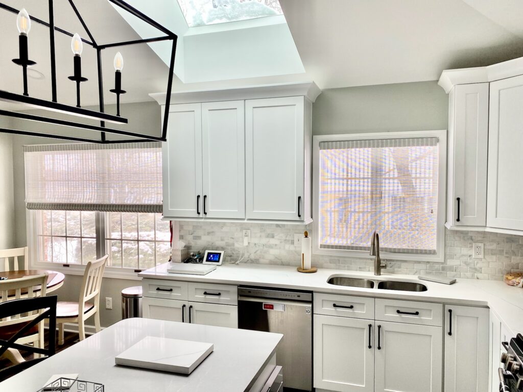 Beautiful modern kitchen with Hunter Douglas Provenance Woven Wood Shades.