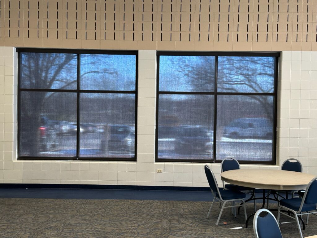 hunter Douglas designer screen shades in large, office windows