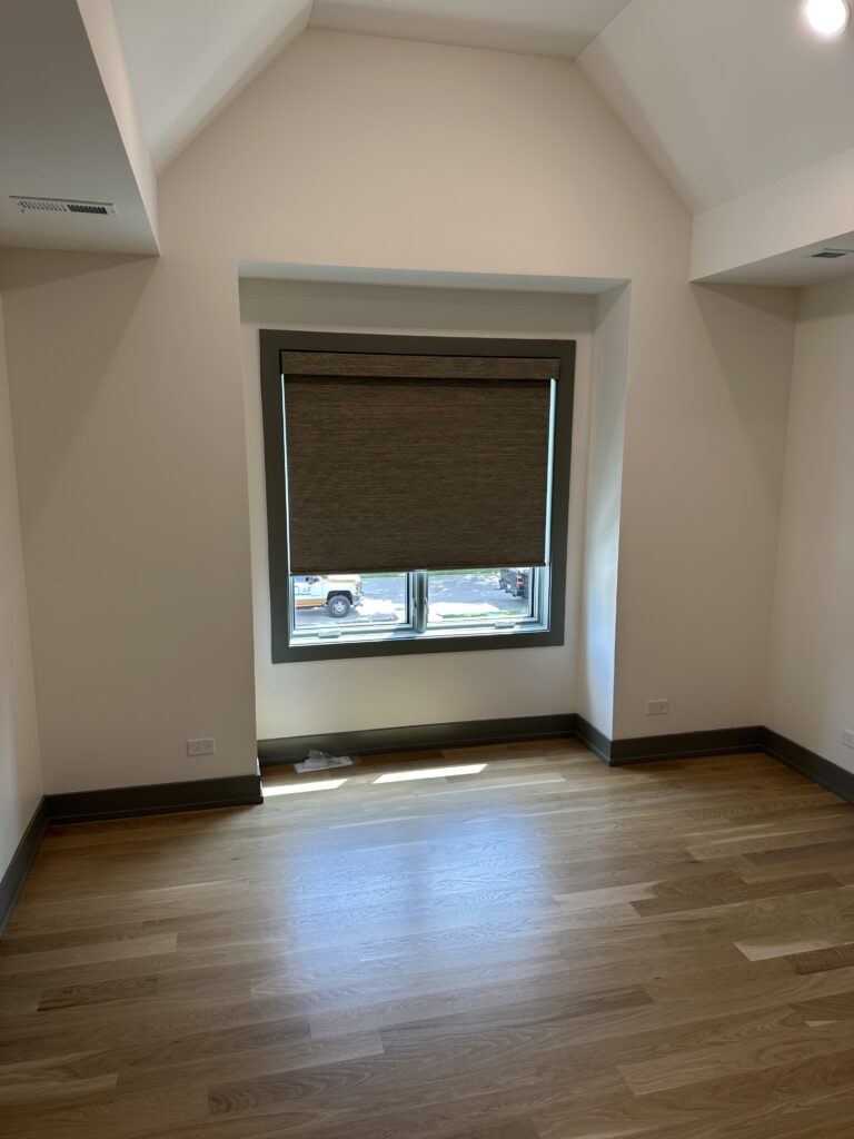 Dark Hunter Douglas Roller shades hanging in an indented window