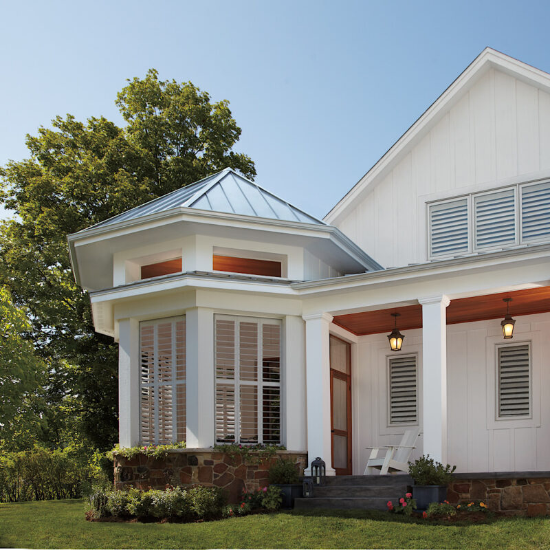 Outside shot of beautiful house with Hunter Douglass shutters in each window