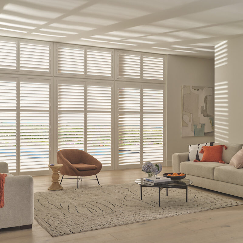 Hunter douglas shutters in neutral living area.