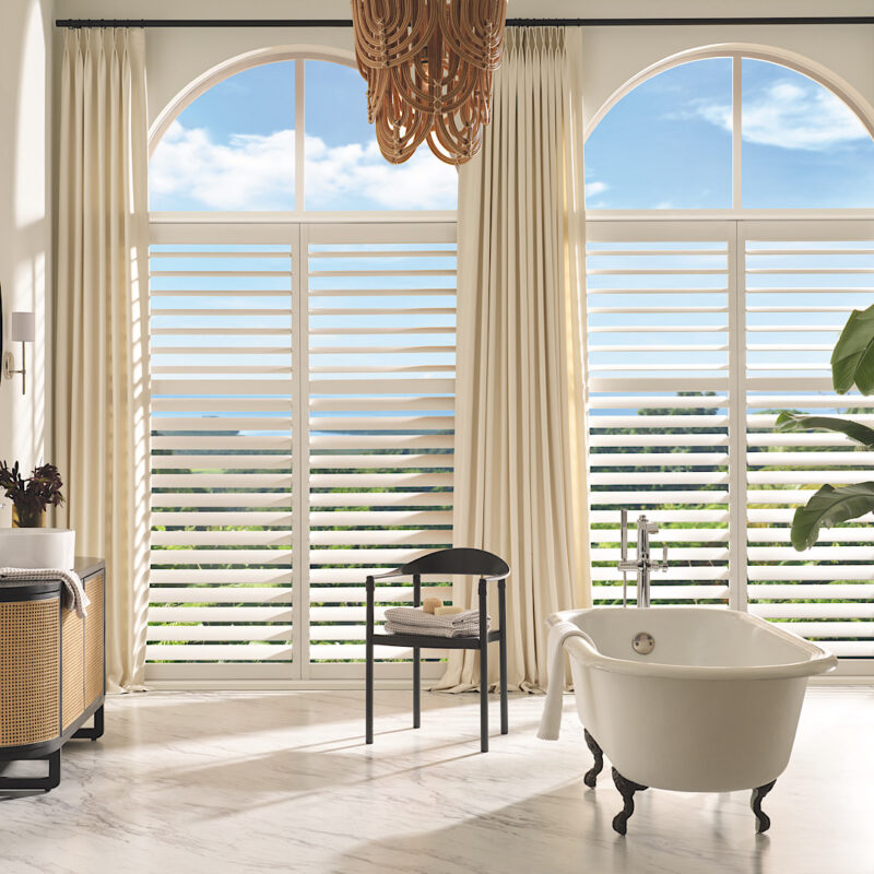 Hunter douglas custom shutters in bathroom arched window