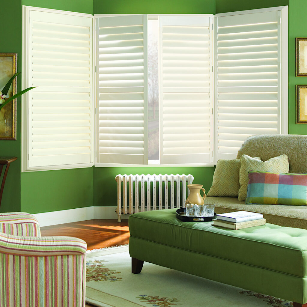 Hunter douglas custom newstyle shutters in green living room