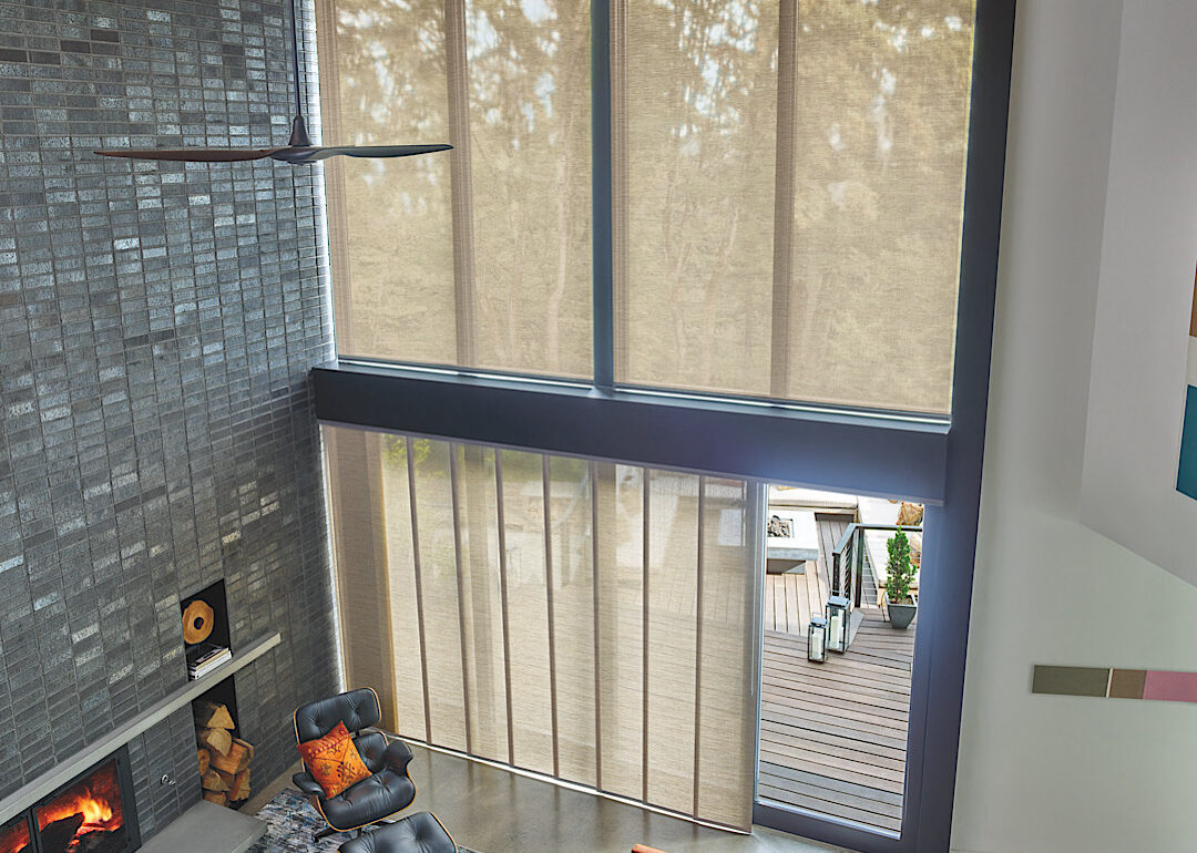 Skyline panel track blinds by hunter douglas over a sliding glass door